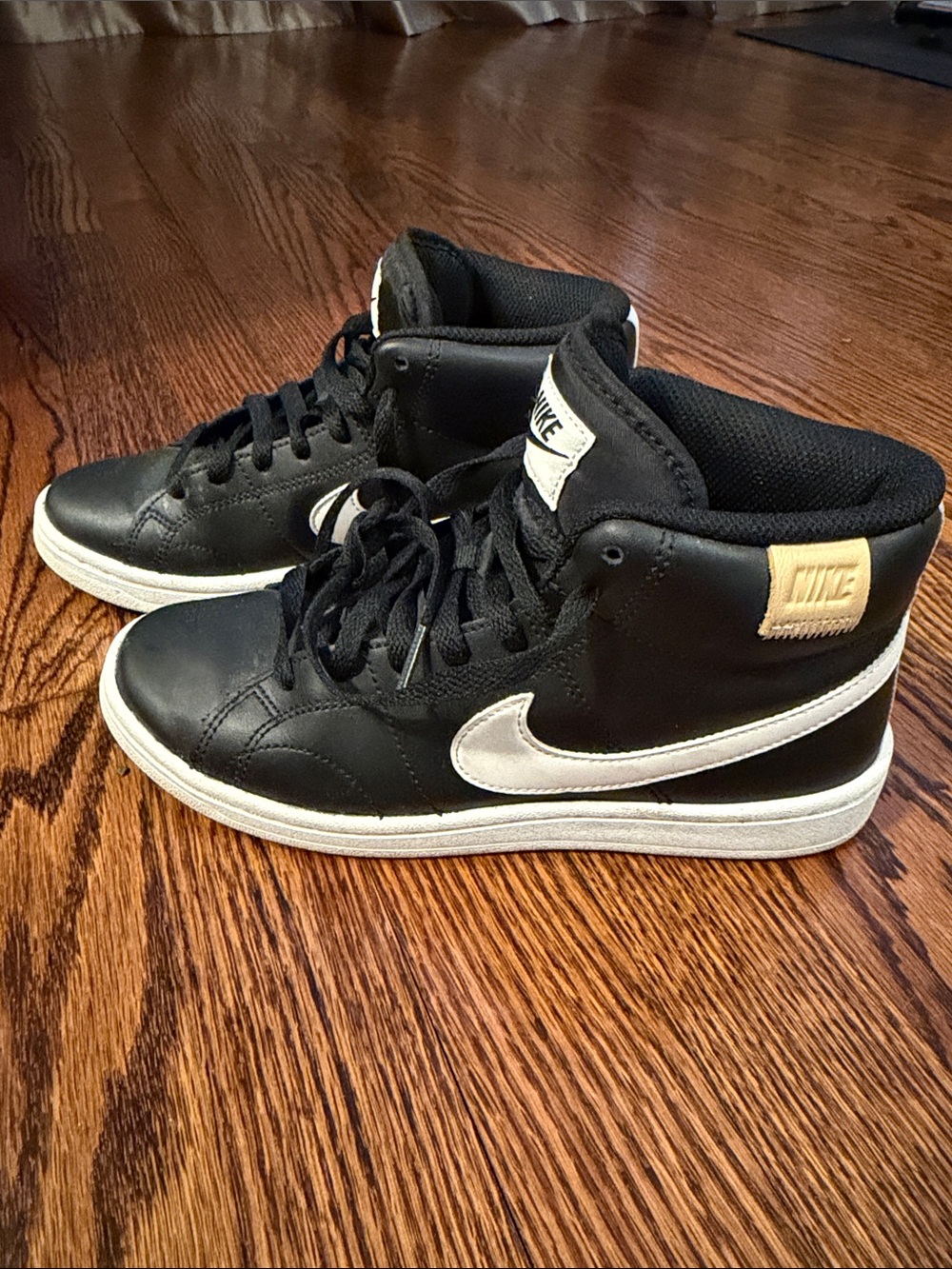 Nike Black High-Top Sneakers with White Swoosh and Cream Patch